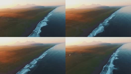 美丽的风景。日落时的大海和群山。乘着直升机沿着海浪飞行高清在线视频素材下载