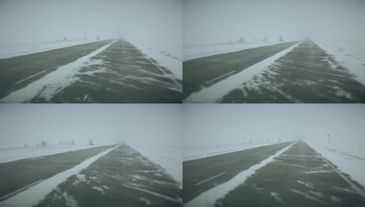 在大雪覆盖的西伯利亚路线上，汽车在一串卡车中行进，侧风阵阵高清在线视频素材下载