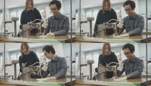 中镜头的两个中年设计专业人员一起工作在纺织制造工作室高清在线视频素材下载
