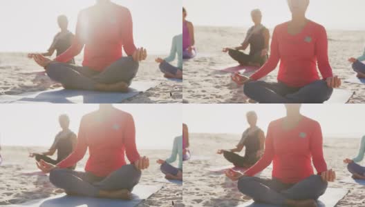 在海滩上做瑜伽的女运动员高清在线视频素材下载
