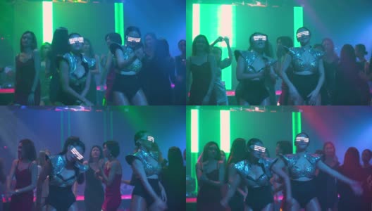 女舞者戴着led光眼镜在俱乐部跳舞高清在线视频素材下载