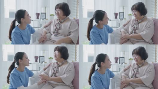 年轻的亚洲妇女或护士在家照顾手在老祖母的肩膀给予支持，同情老年妇女或老年人在辅助生活家庭照顾精神健康疾病救济的概念。高清在线视频素材下载
