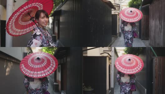一名日本女子在一条狭窄的小路上行走——撑着纸伞高清在线视频素材下载
