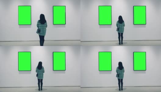 一个年轻的女人在画廊里看绿色的镜框高清在线视频素材下载