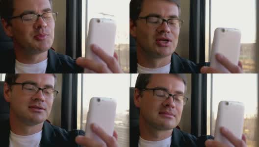 一名男子在火车上用手机视频聊天高清在线视频素材下载