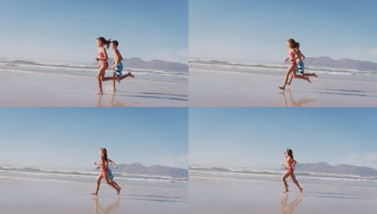 暑假里男孩和女孩一起在海滩上跑步高清在线视频素材下载