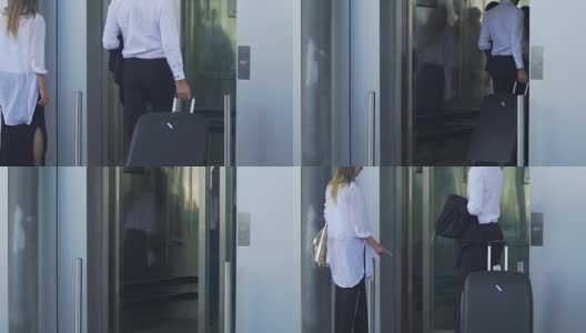 一男一女走向电梯门，进入电梯，一男提着行李箱高清在线视频素材下载