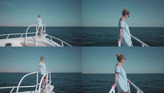 一个年轻美丽的白人女人在游艇上的肖像穿着蓝色的裙子和太阳镜。假期的概念，自由，阳光夏日。背景是蓝色的海洋。steadycam高清在线视频素材下载