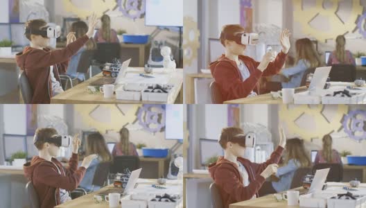 在计算机科学课上，戴着虚拟现实耳机的男孩正在做一个编程项目。高清在线视频素材下载