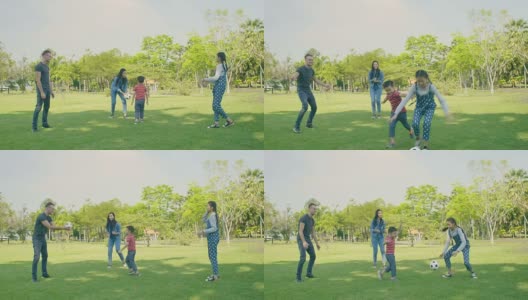 孩子和父母在公园里踢足球。缓慢的运动。高清在线视频素材下载
