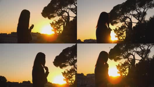 落日对城市的魔力:孤独的女人凝视着夕阳高清在线视频素材下载