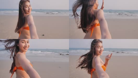 少女在海滩上散步。穿着泳装的漂亮女孩。享受,生活方式,自由,旅行。暑假的概念。高清在线视频素材下载