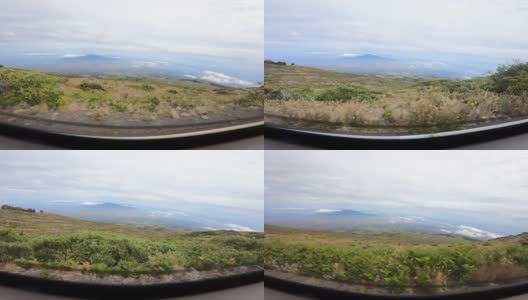 POV从车的后视镜看下山，显示了美丽的山景在路边。慢动作，高角度视图。夏威夷群岛。高清在线视频素材下载