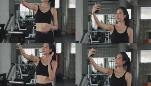 一位美女在健身房里用智能手机自拍。高清在线视频素材下载