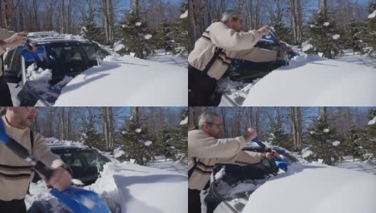 一个阳光明媚的冬日，一名50岁的白人男子正在用铲子清理他停在车道上的车。高清在线视频素材下载