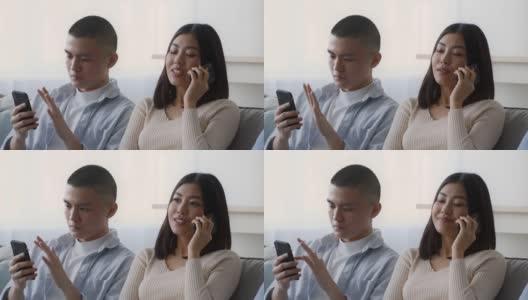 亚洲夫妇在家里使用智能手机和通过电话交谈高清在线视频素材下载