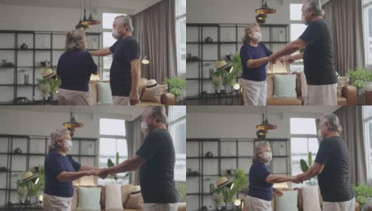 亚洲老年幸福夫妇居家隔离的概念，亚洲老年退休夫妇在客厅一起跳舞，快乐快乐的时刻，可爱的老年夫妇在家里跳舞高清在线视频素材下载