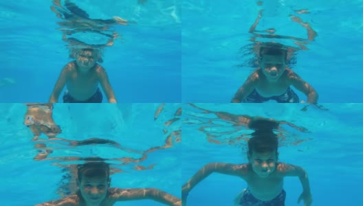 孩子睁着眼睛潜到水下，小男孩在暑假期间在游泳池的蓝色水里游泳高清在线视频素材下载