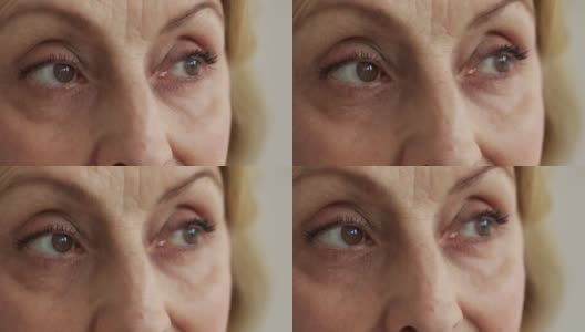 一位上了年纪的妇女悲伤的棕色眼睛在看别处，这是特写镜头高清在线视频素材下载