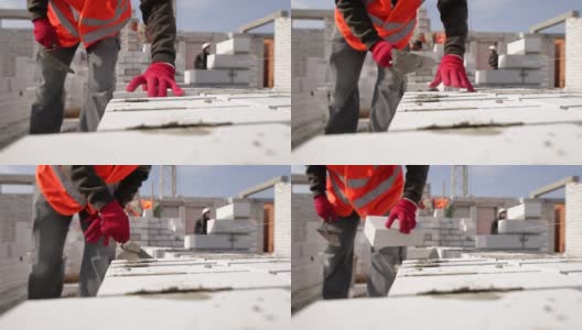 砌砖工人用抹刀涂水泥高清在线视频素材下载