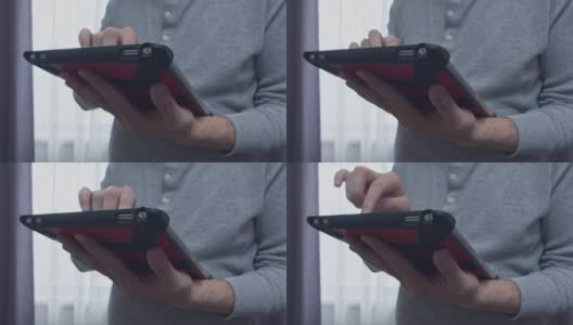 《Standing Man》使用红色硬壳平板电脑(触摸和滑动操作)高清在线视频素材下载