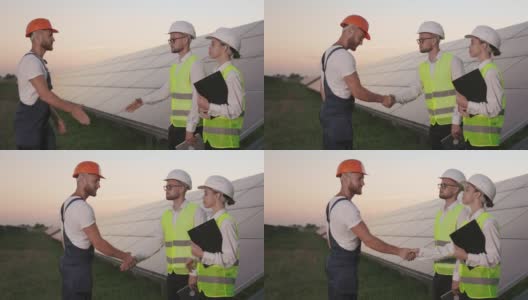 在太阳能农场，工头和检查员握手问候。高清在线视频素材下载