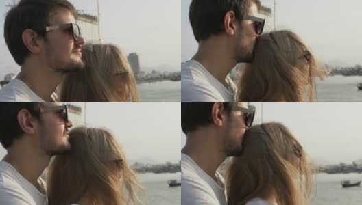 日落时分，海滩上一对戴着墨镜的情侣的特写镜头高清在线视频素材下载