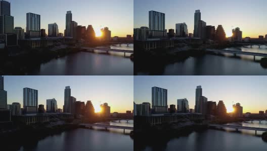 阳光灿烂，随着太阳升起在摩天大楼之间沿着奥斯丁城市天际线鸟瞰图在奥斯丁德克萨斯州在日出剪影的城市高清在线视频素材下载