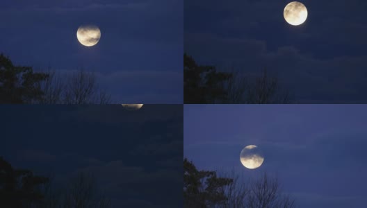 满月穿过深蓝色的云层，时光流逝高清在线视频素材下载