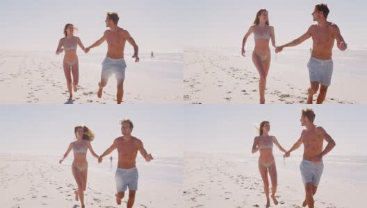 穿着泳衣的情侣一起在夏天的海滩上跑步高清在线视频素材下载