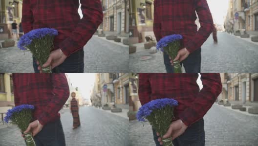一个男人送花给一个年轻的女孩。慢动作高清在线视频素材下载