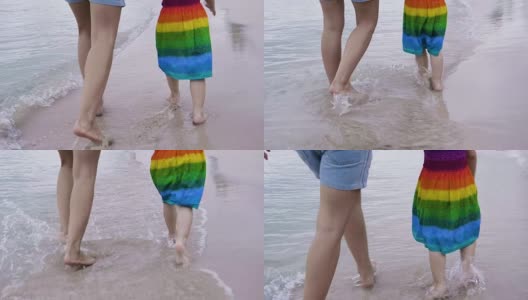 慢镜头:妈妈和她的小女儿在海边跑步高清在线视频素材下载