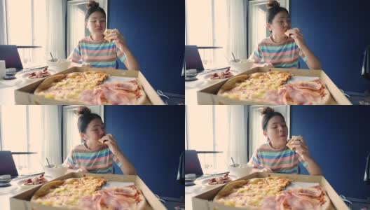 年轻漂亮的女人在家吃披萨。高清在线视频素材下载