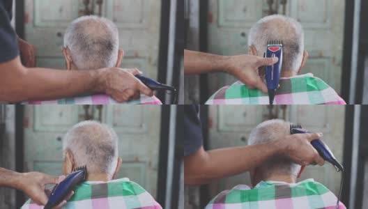 4K分辨率的父子老人在室内用理发器在家梳洗。在冠状病毒隔离期间，请呆在家里理发。自己动手，理发师。东南亚的泰国高清在线视频素材下载
