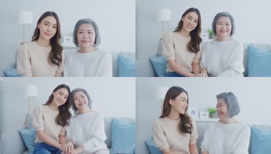 亚洲可爱家庭的肖像，年轻的女儿坐在年长的母亲。漂亮的女人和年长的成熟妈妈一起坐在客厅沙发上享受家里的活动，微笑着看着镜头高清在线视频素材下载