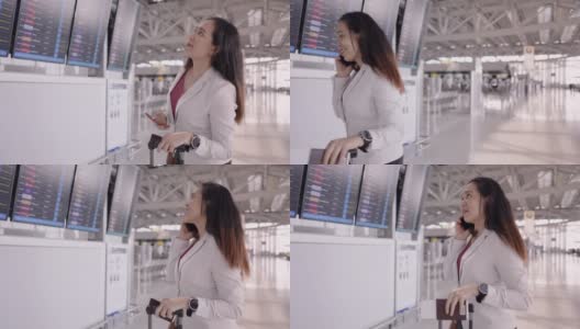 女商人在机场沟通预订航班，亚洲女商人，检查航班的时间，使她的商务旅行在屏幕上看到航班号，使用电话做生意，在国外工作高清在线视频素材下载