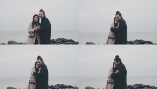 一对幸福的情侣在多云的日出中漫步在荒野的海滩上高清在线视频素材下载