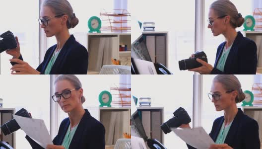 一名女性高管在办公桌前查看拍摄的照片，时间是4k高清在线视频素材下载