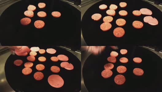 厨师将土耳其香肠(sucuk)和意大利腊肠放在黑色平底锅上高清在线视频素材下载