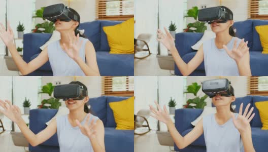 近距离的年轻亚洲女性使用虚拟现实眼镜与幸福而坐在家里客厅的运动垫，人们在幸福的时刻，Z一代的生活方式高清在线视频素材下载