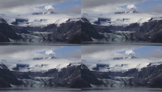 约翰·霍普金斯冰川和它周围的雪山和云。阿拉斯加的冰川湾景观。高清在线视频素材下载