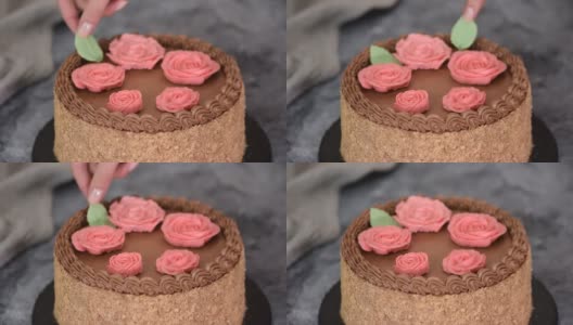 女性用奶油花和树叶装饰自制基辅蛋糕高清在线视频素材下载