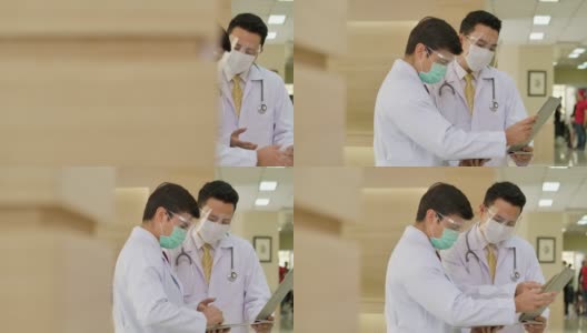 两位医生在医院大厅里互相讨论。高清在线视频素材下载