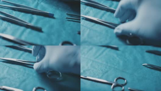 外科医生从医用托盘中取缝线的双手高清在线视频素材下载