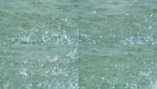 慢镜头:雨滴落在海水中的微距镜头高清在线视频素材下载