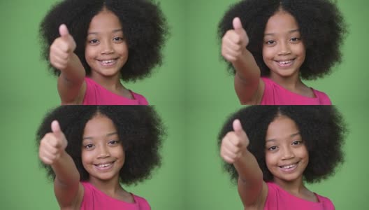 年轻可爱的非洲女孩，有着非洲式的头发，竖起大拇指高清在线视频素材下载
