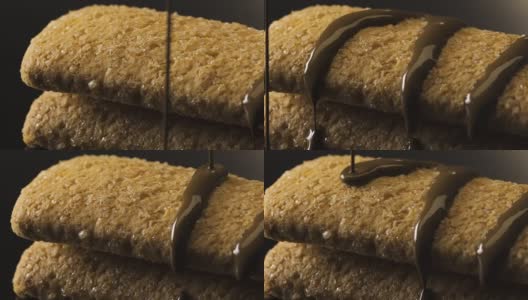 黑色背景上的饼干上正在融化的巧克力高清在线视频素材下载