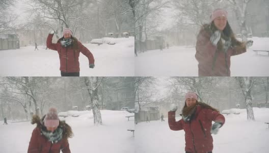 年轻女子在户外享受冬日。雪的冬天的梦想。慢动作高清在线视频素材下载