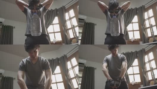 亚洲男人在家里锻炼举起塑料加仑水瓶高清在线视频素材下载