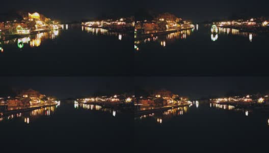越南广南会安——2020年3月8日:在Thu Bon河上，游船带着漂浮的灯笼。视图。桥。人们在河边散步，会安，联合国教科文组织世界遗产。高清在线视频素材下载